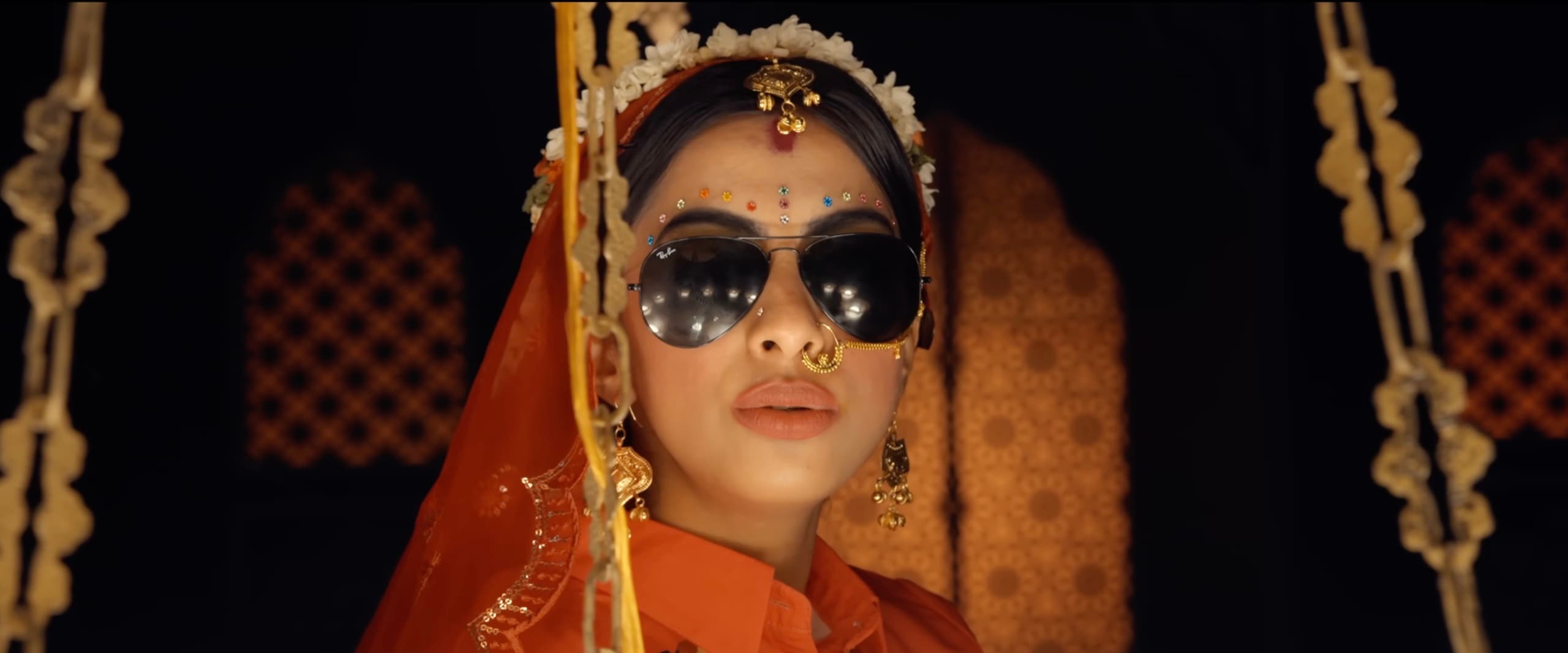 Ranjani in a saffron bridal look wearing aviator sunglasses